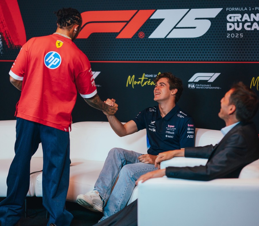 Colapinto en la conferencia de prensa protocolar de los jueves en la Fórmula 1 saluda a Lewis Hamilton.