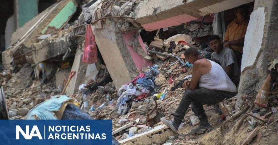 DOBLE TERREMOTO. Personas sentadas sobre los escombros de un edificio colapsado en Caraballeda, estado La Guaira.